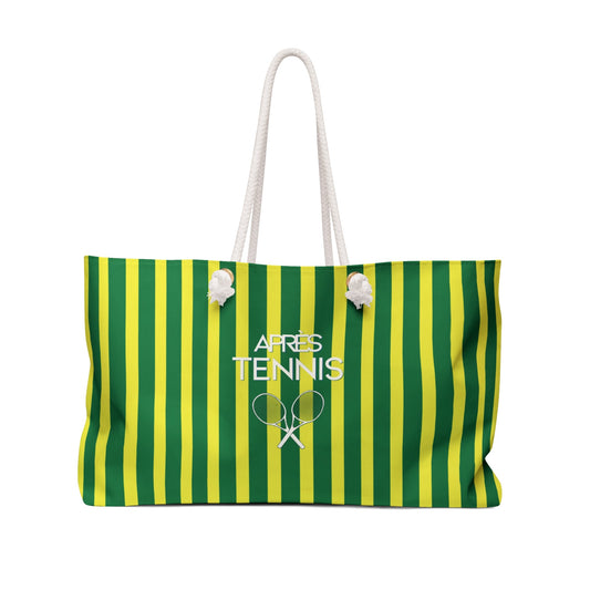 Green and yellow striped weekender tote bag with white rope handles and front charm