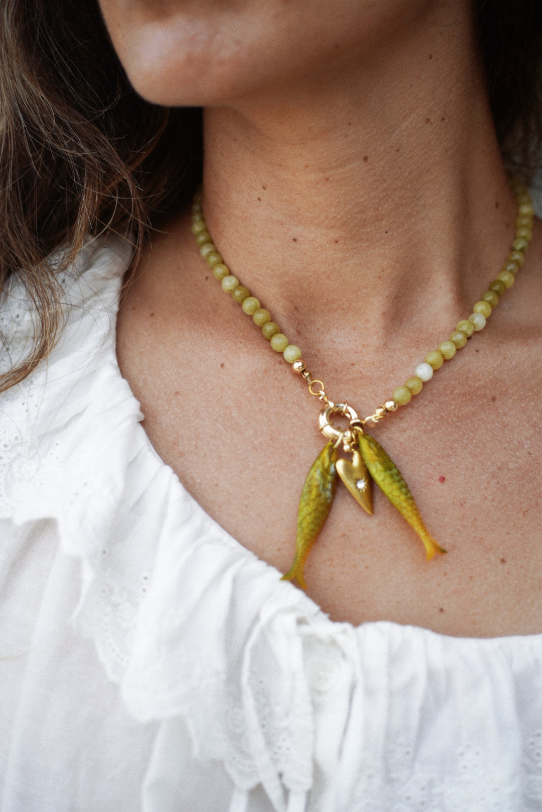 Olive bead fish pendant necklace with gold clasp and twin dangling fish charms