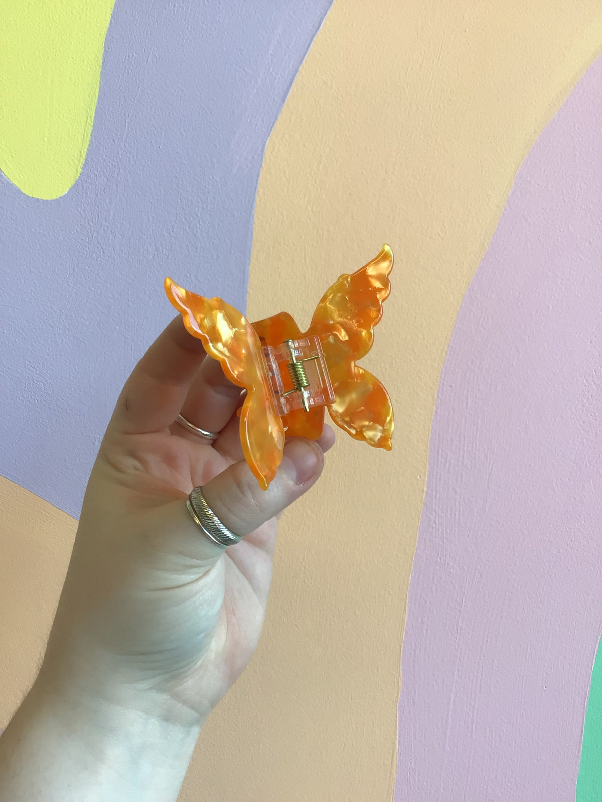 Butterfly hair claw with amber orange iridescent wings and metal hinged clip