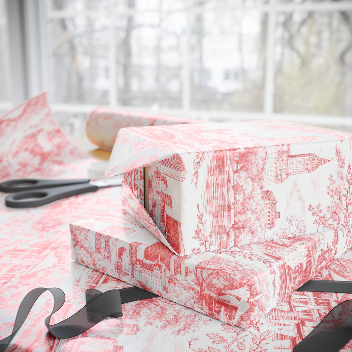 Red and white toile wrapping paper wrapped gifts stacked with black ribbon