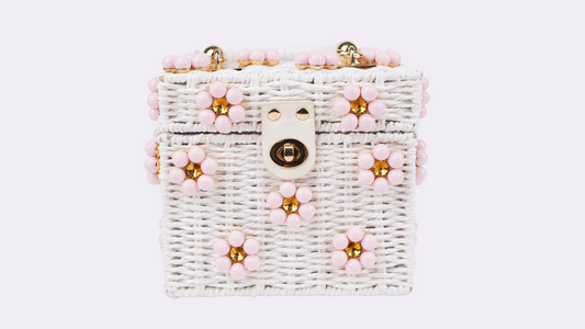 Woven white beaded handbag with pink floral bead accents and gold clasp