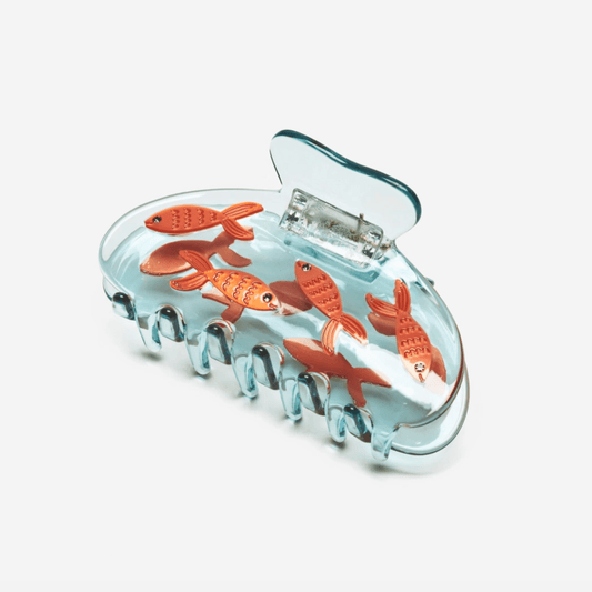 Transparent blue fish hair claw with orange goldfish cutouts and molded grip teeth