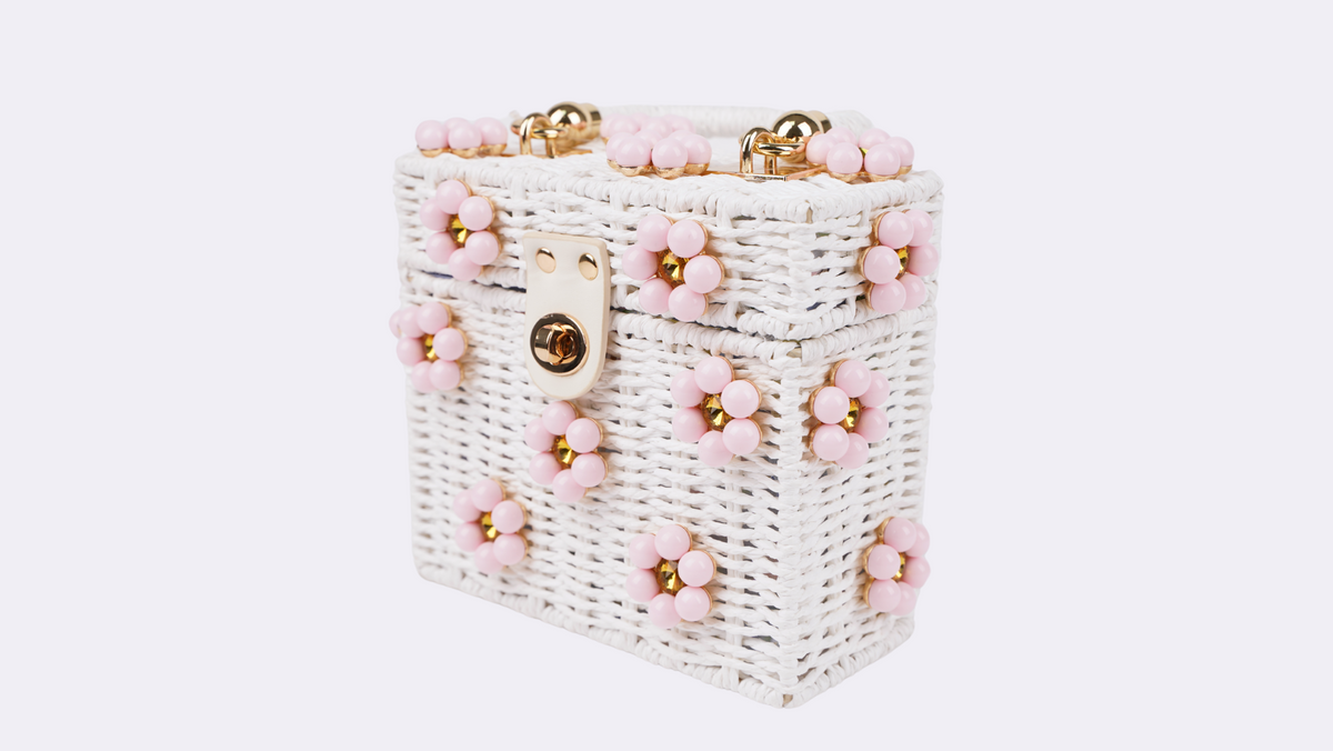 Woven white beaded handbag with pink bead trim, gold hardware, and handle