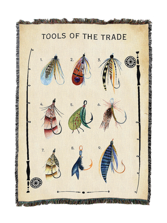 Beige fly fishing blanket with numbered lure illustrations and fringed border