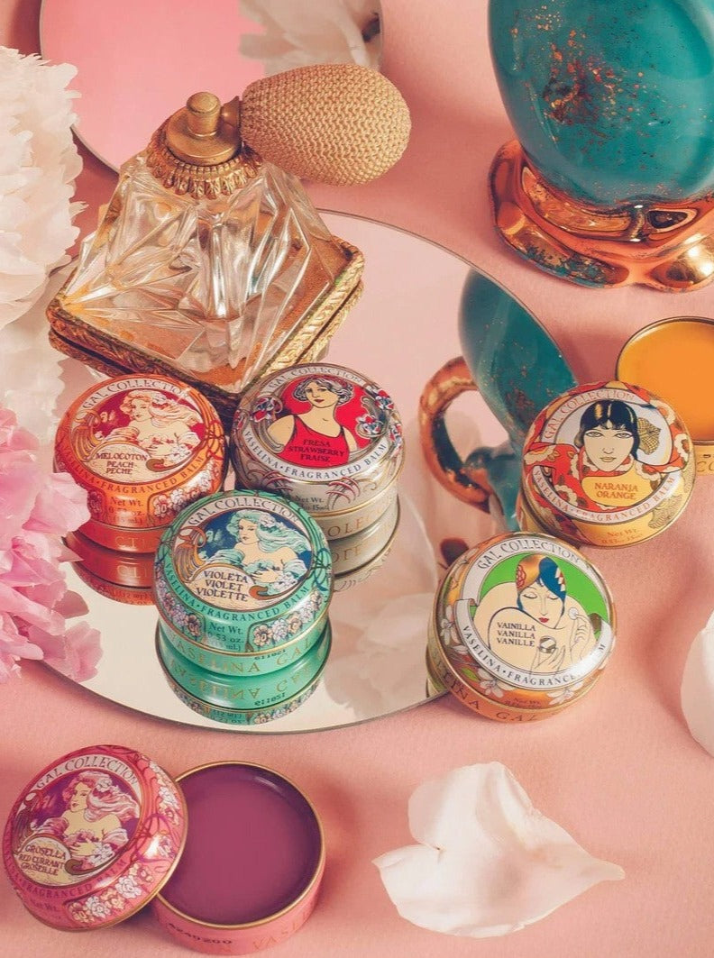 Perfumeria Gal scented lip balm tins in assorted colors, including an open pink balm