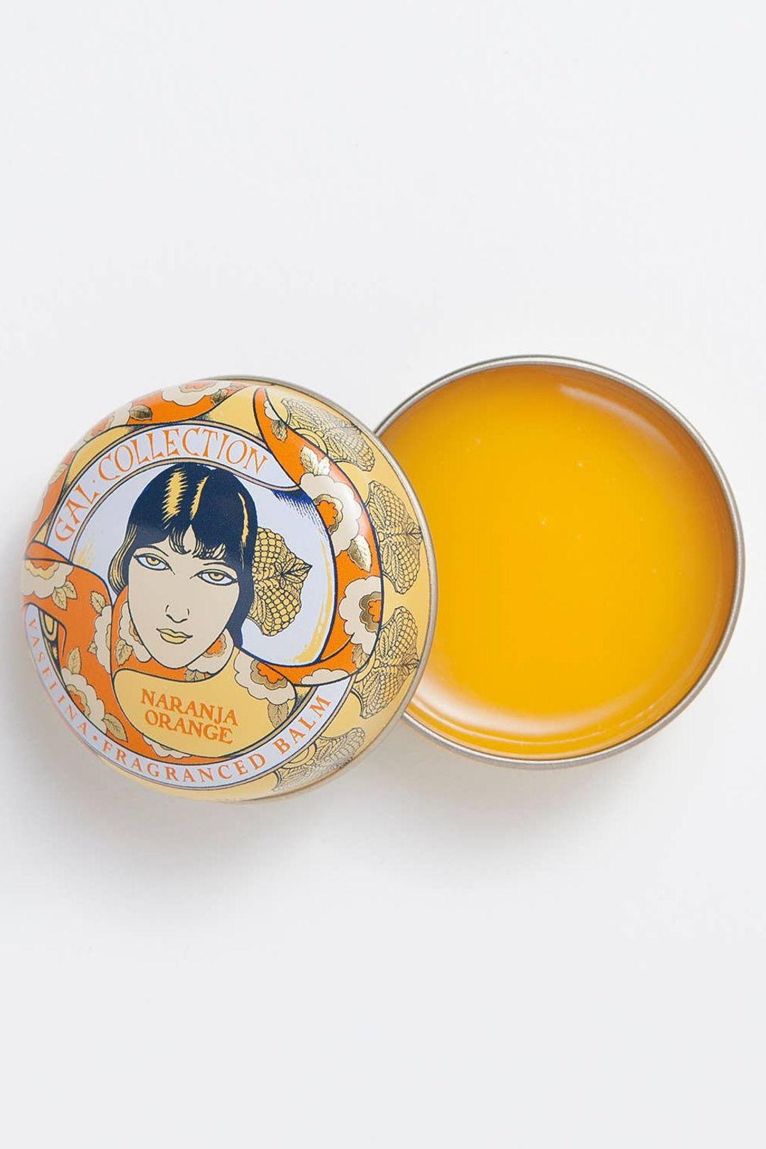 Perfumeria Gal orange-scented lip balm in an open tin with illustrated lid