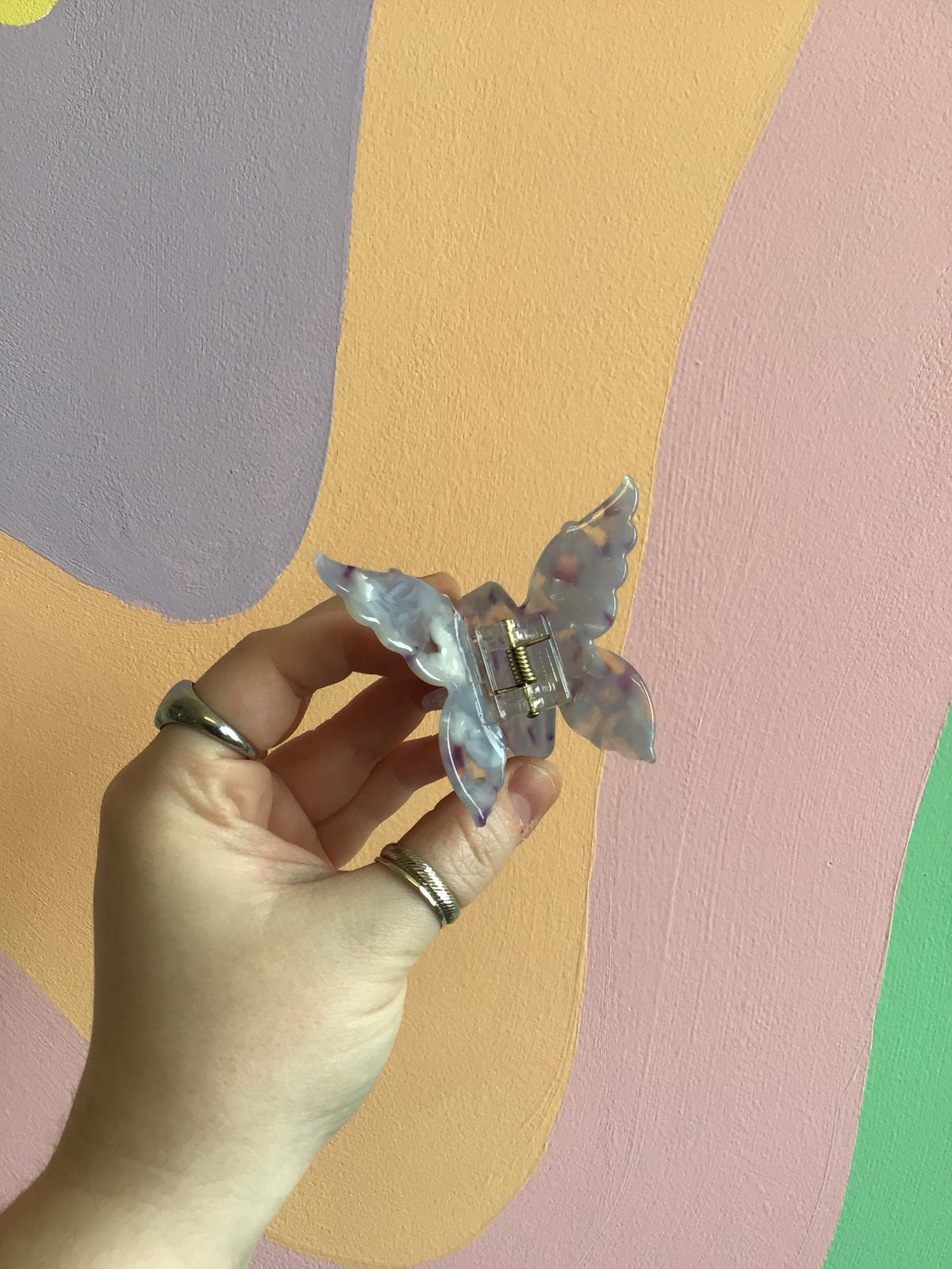 Butterfly hair claw with translucent light-blue wings and gold-tone center hinge