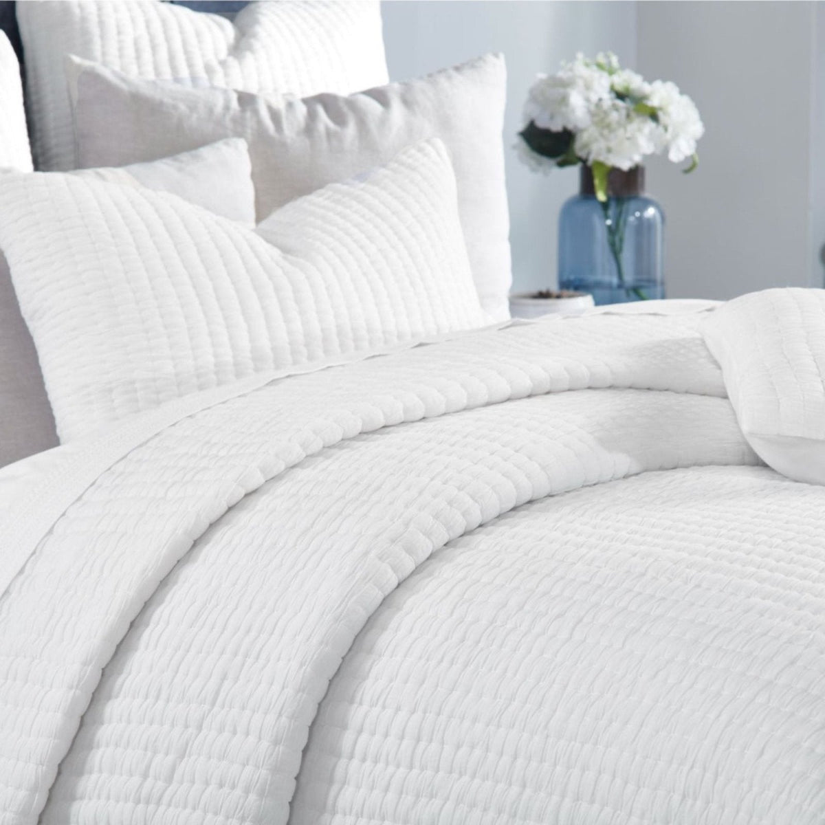 Off-white quilted cotton with crinkle texture and prominent stitched rows