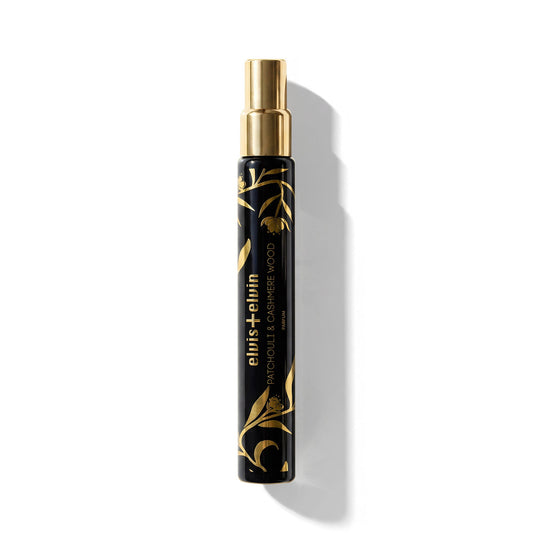 Patchouli and Cashmere Wood perfume spray bottle with gold cap and black cylinder