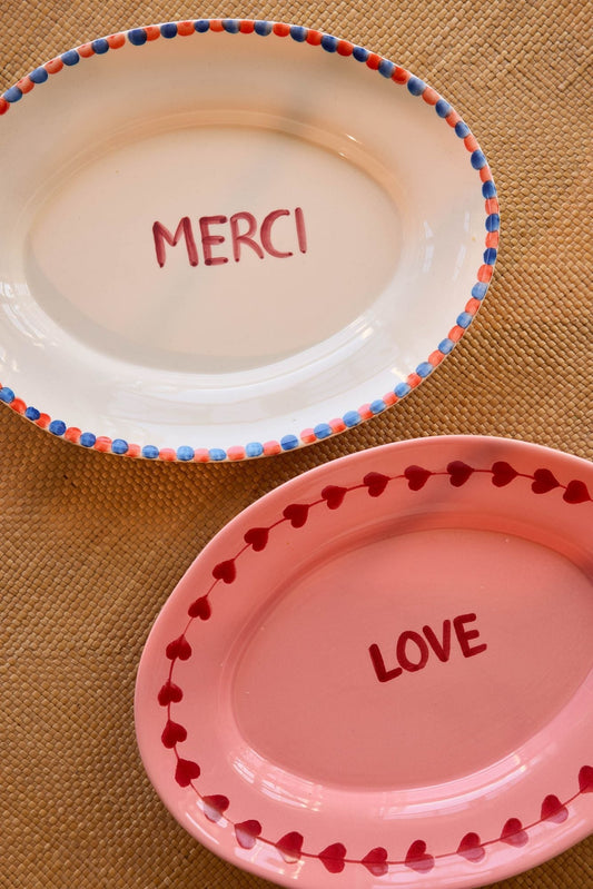 Ceramic serving platters: pink LOVE with red heart border and white MERCI with blue border