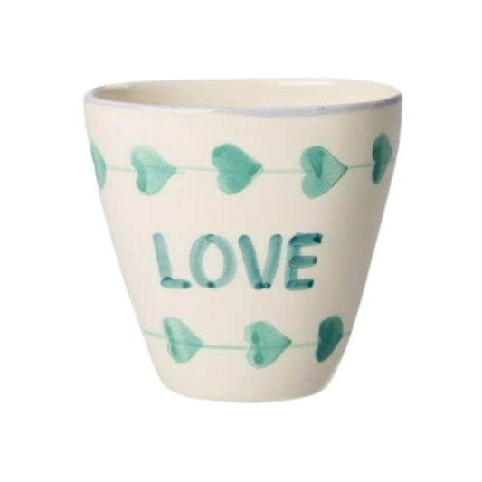 Ceramic oval cup with hand-painted green LOVE, white with teal bow pattern.