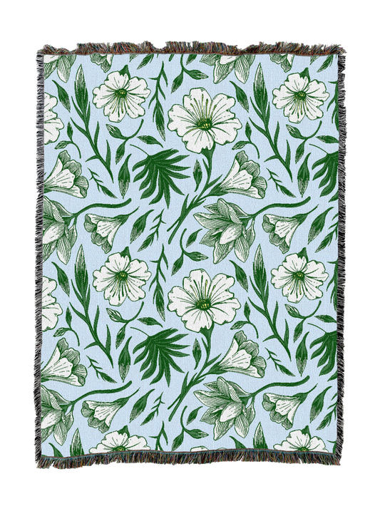 Floral throw blanket with white flowers and green vines, fringed border