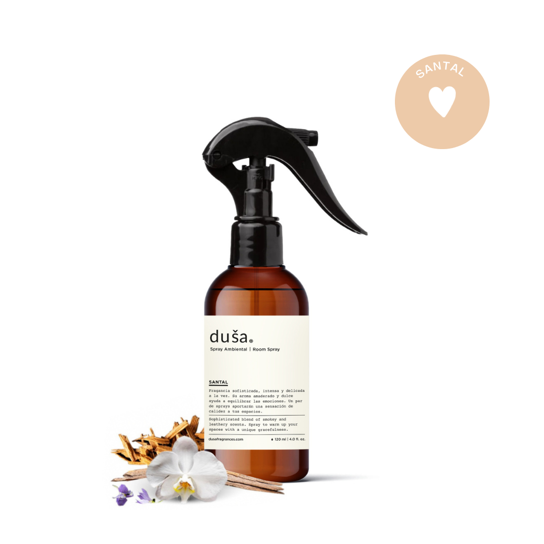 SANTAL room & linen spray bottle with orchid and other botanicals beside it