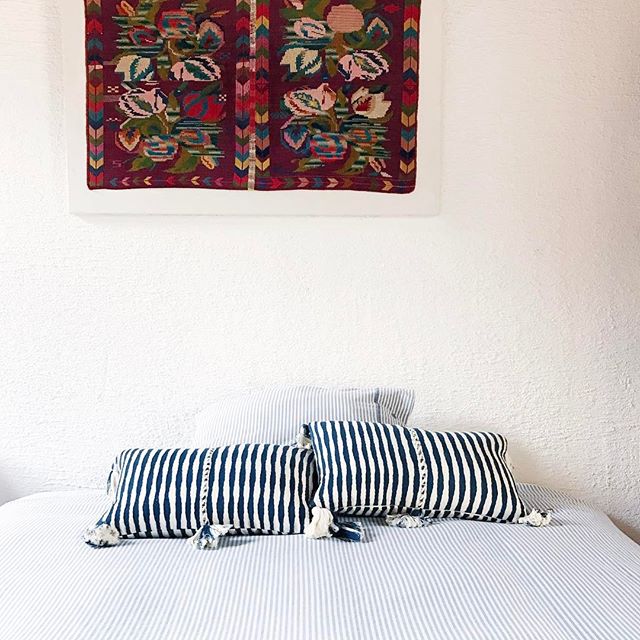 Set of striped pillows with dark teal and white stripes and tassel fringe corners