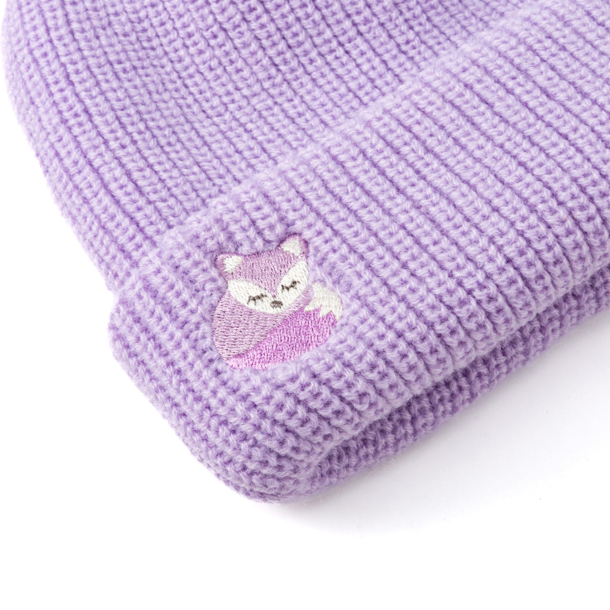 Close-up of purple beanie cuff with embroidered fox detail