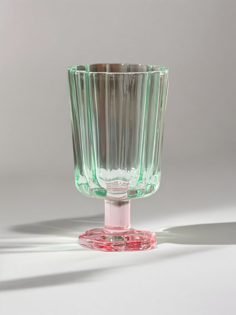 Hand-blown petal goblet glass, clear mint green, on red flared base.