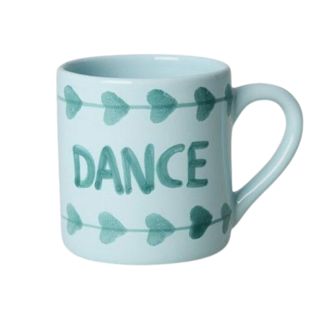 Light blue ceramic mug with green hand-painted DANCE text and bow-shaped accents