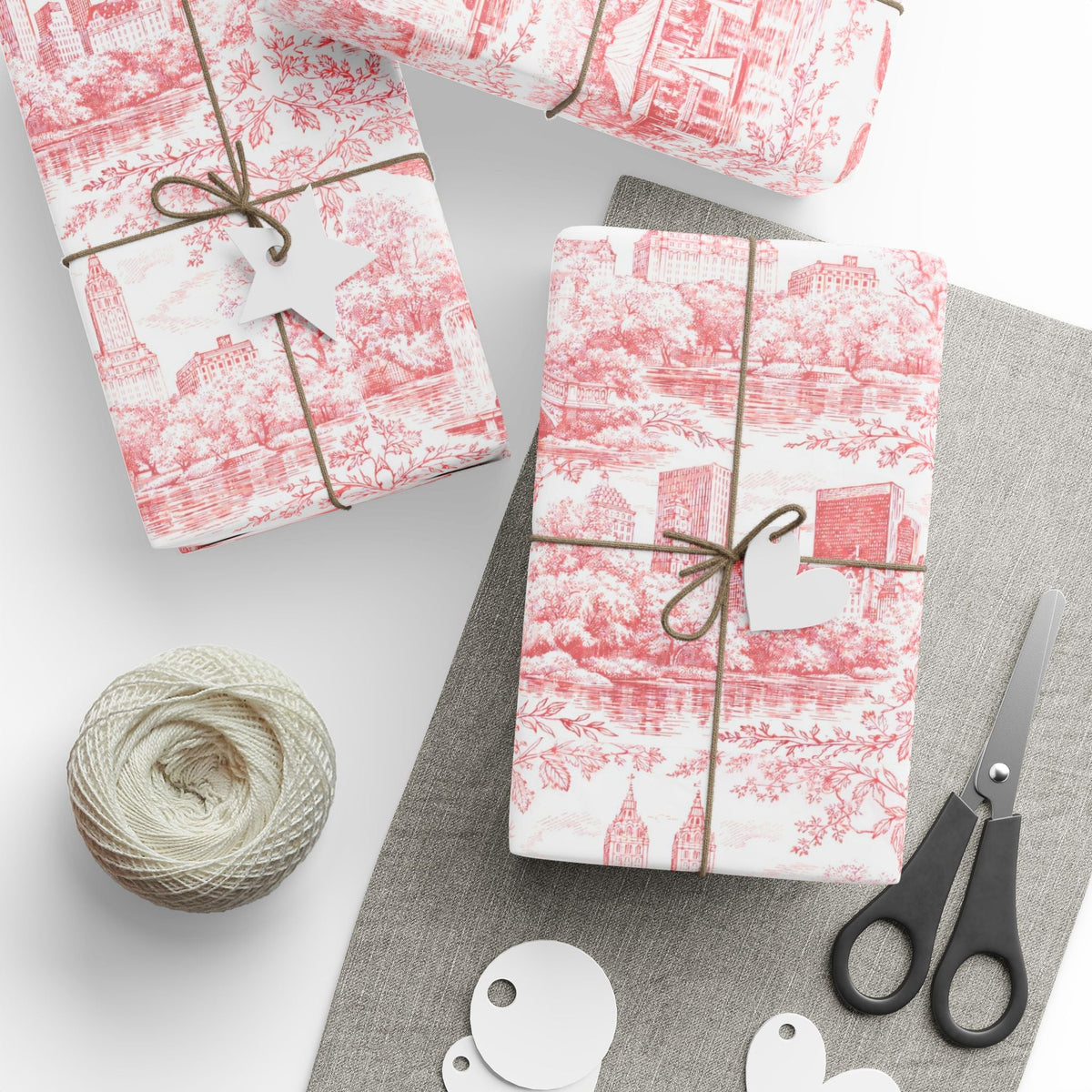 Red and white toile wrapping paper gift boxes with ribbon ties and scissors