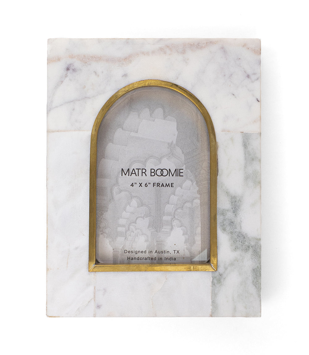 White marble arched picture frame with brass-toned inlay border, front view