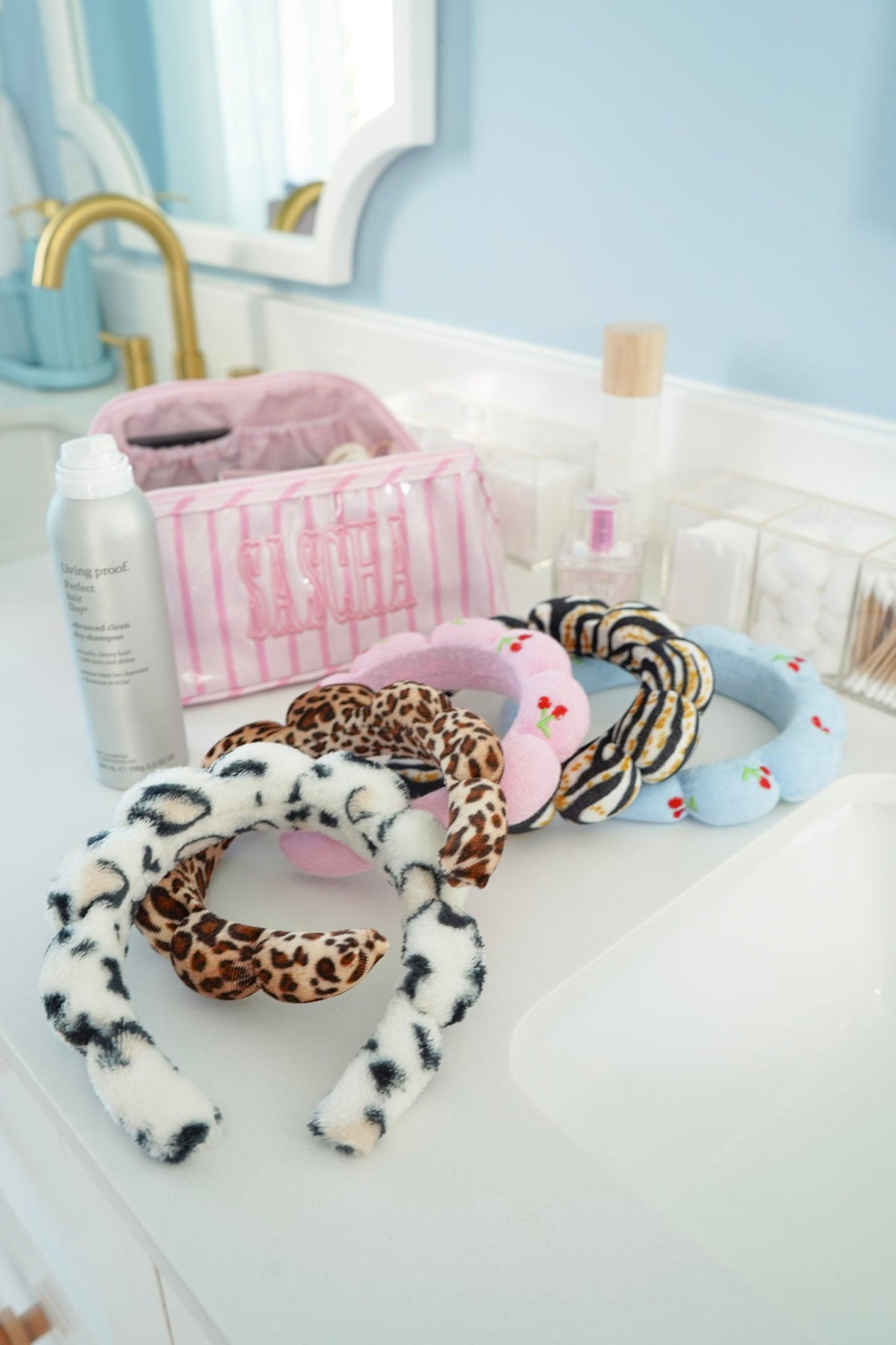Plush animal-print braided headbands with leopard, zebra, and pastel blue loops