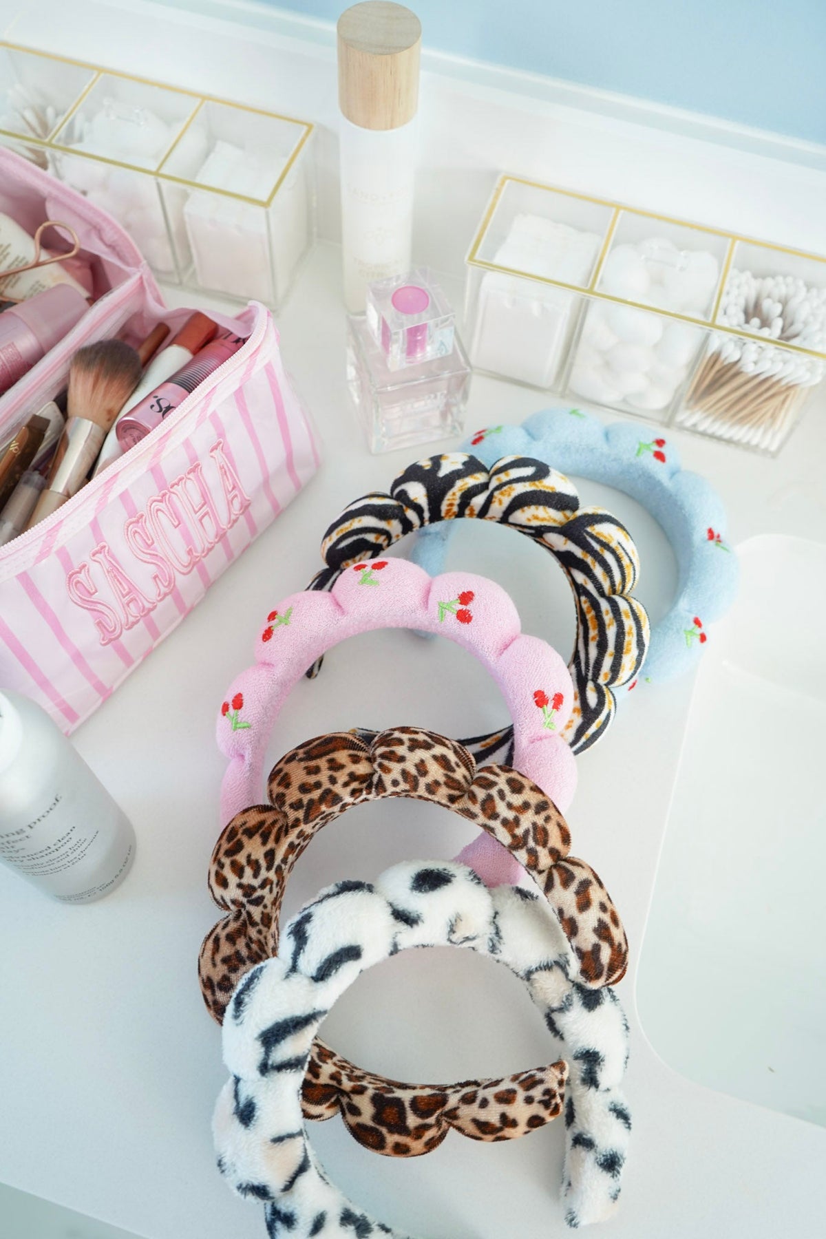 Plush fabric headbands set with light blue, pink, leopard print, and black-and-yellow stripes