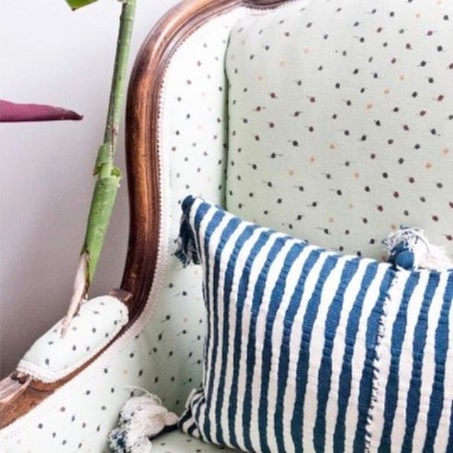 Navy-blue and white striped pillow with corner fringe tassels