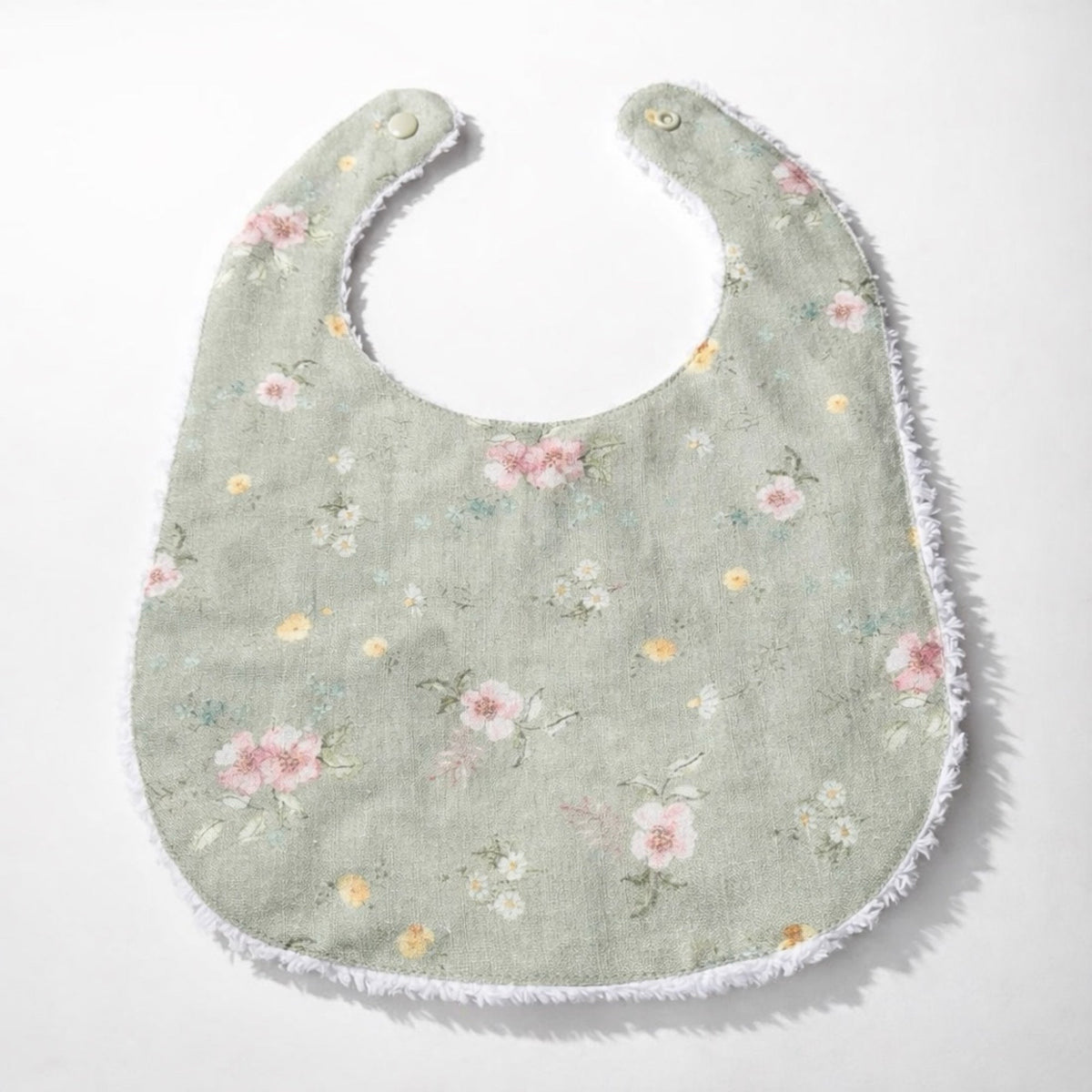 Infant linen bib in gray-green with multicolor floral print and stitched border