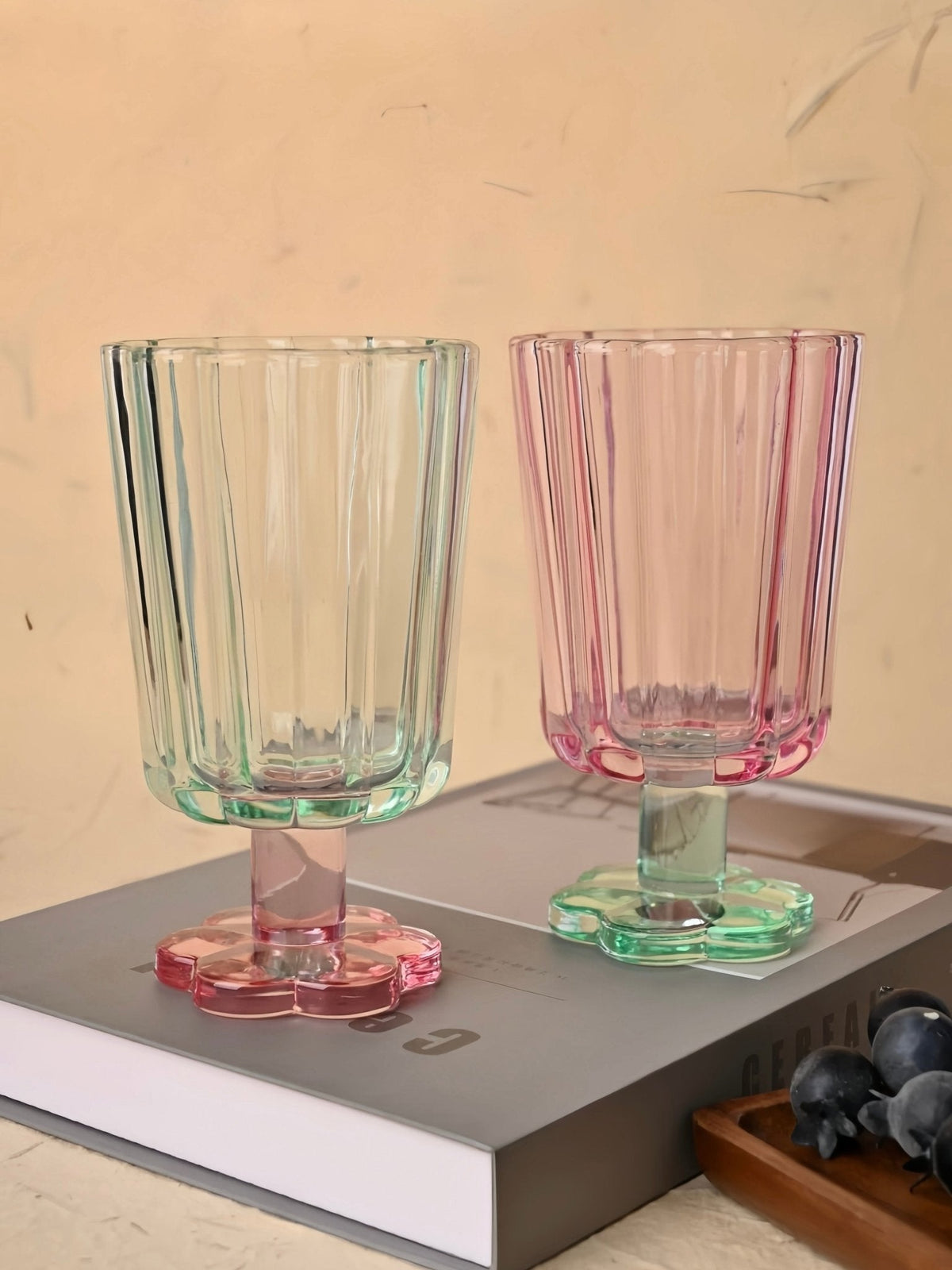 Hand-blown petal goblet glasses, mint green and pink, stemmed bases with scalloped rims.