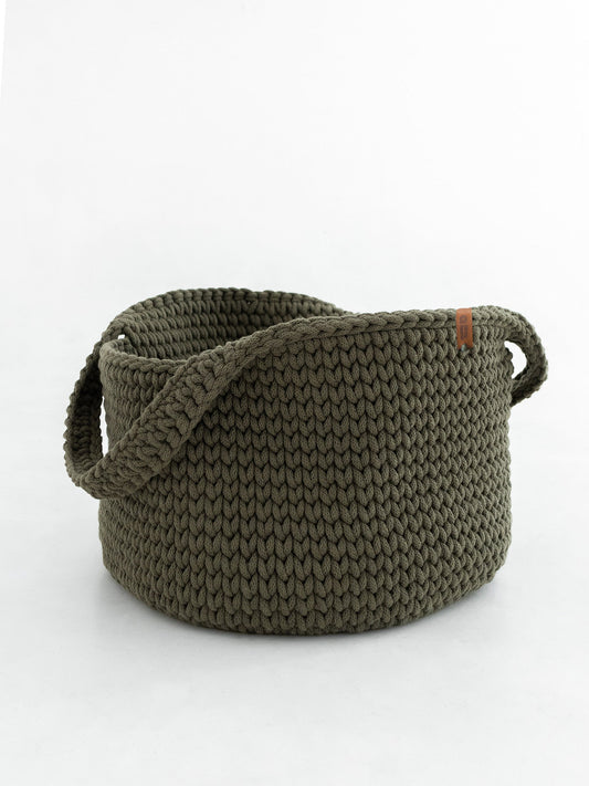 Round woven basket with handles, olive-green knit texture.