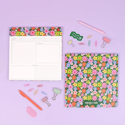 Floral paper notepad with pastel flower pattern cover and ruled pages layout