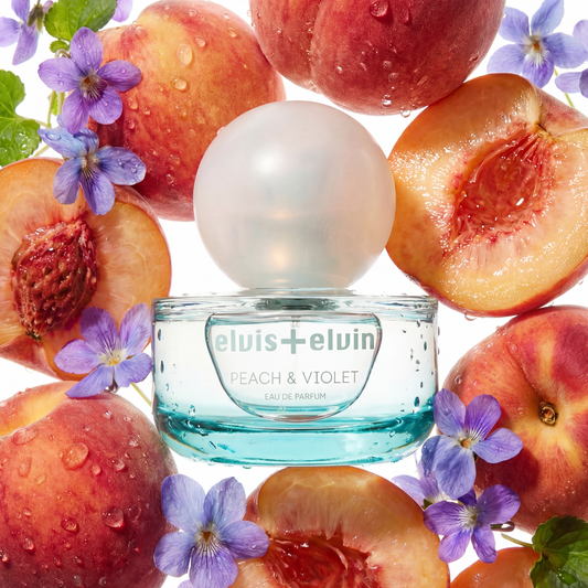 Peach & Violet eau de parfum bottle with blue glass jar, peaches and purple flowers