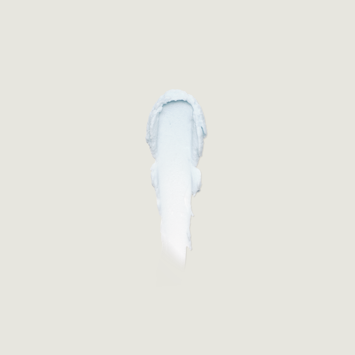 Swirl of pale blue whipped balm on a small applicator