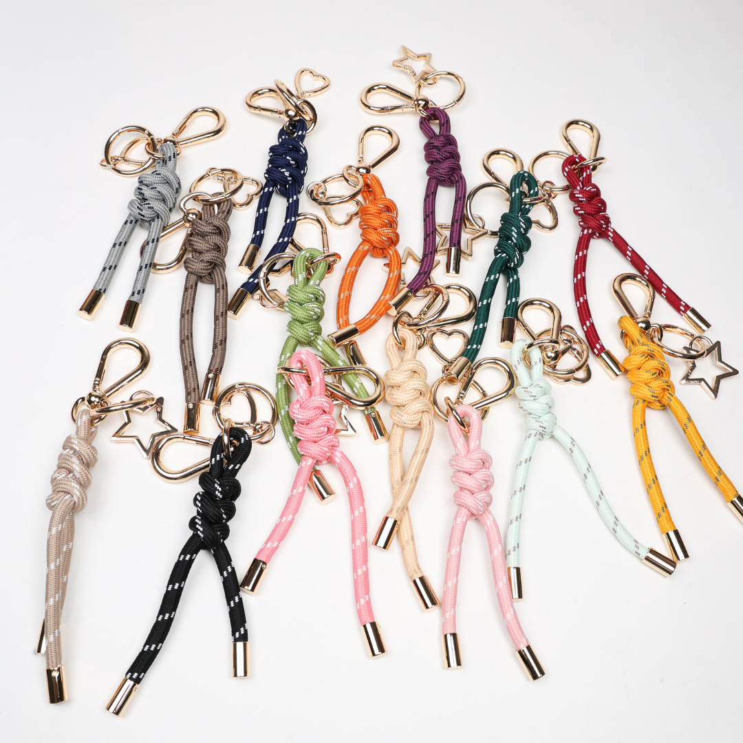 Assorted paracord key chains with gold-tone clasps in multiple colors
