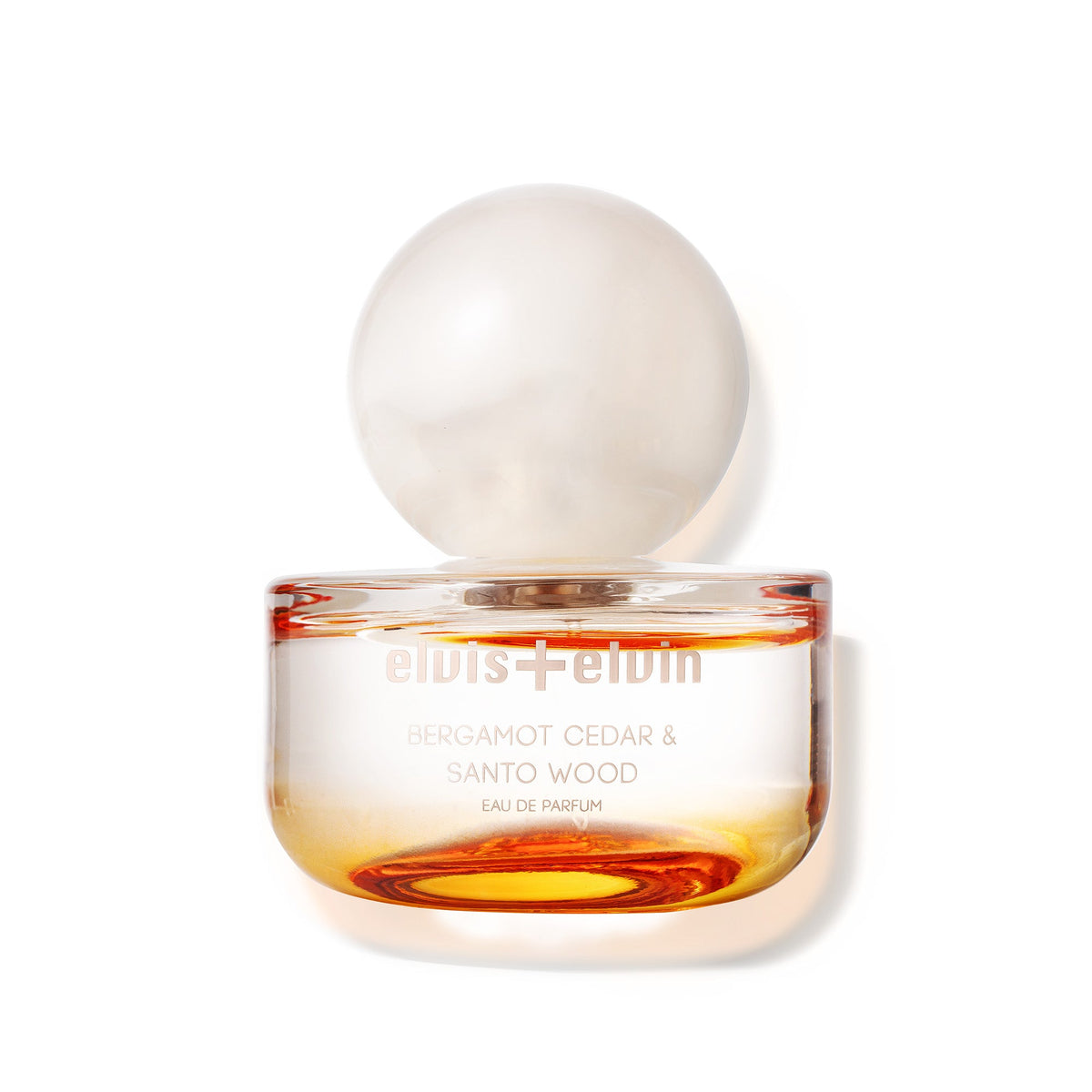 Glass eau de parfum bottle with amber liquid and clear globe cap, Bergamot Cedar & Santo Wood