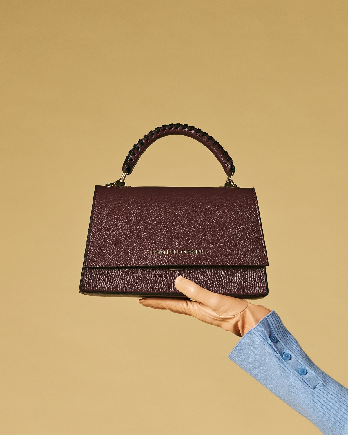 Eggplant leather crossbody bag with top flap and braided handle, gold-tone hardware