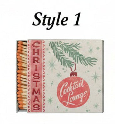 Holiday matchbox with Christmas wreath graphic and 'Cocktail Lounge' badge; exposed matchsticks