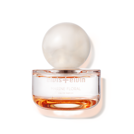 Marine floral eau de parfum bottle with amber liquid and round glass cap