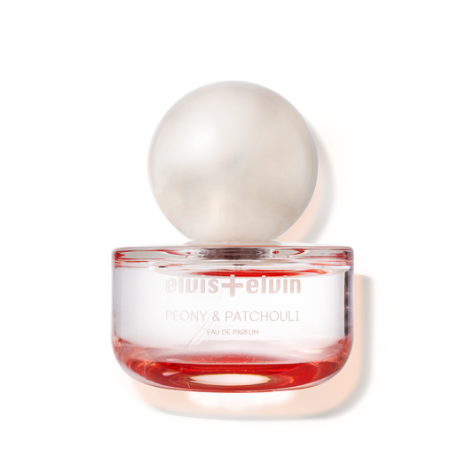 Peony & patchouli eau de parfum jar with clear dome lid and red liquid