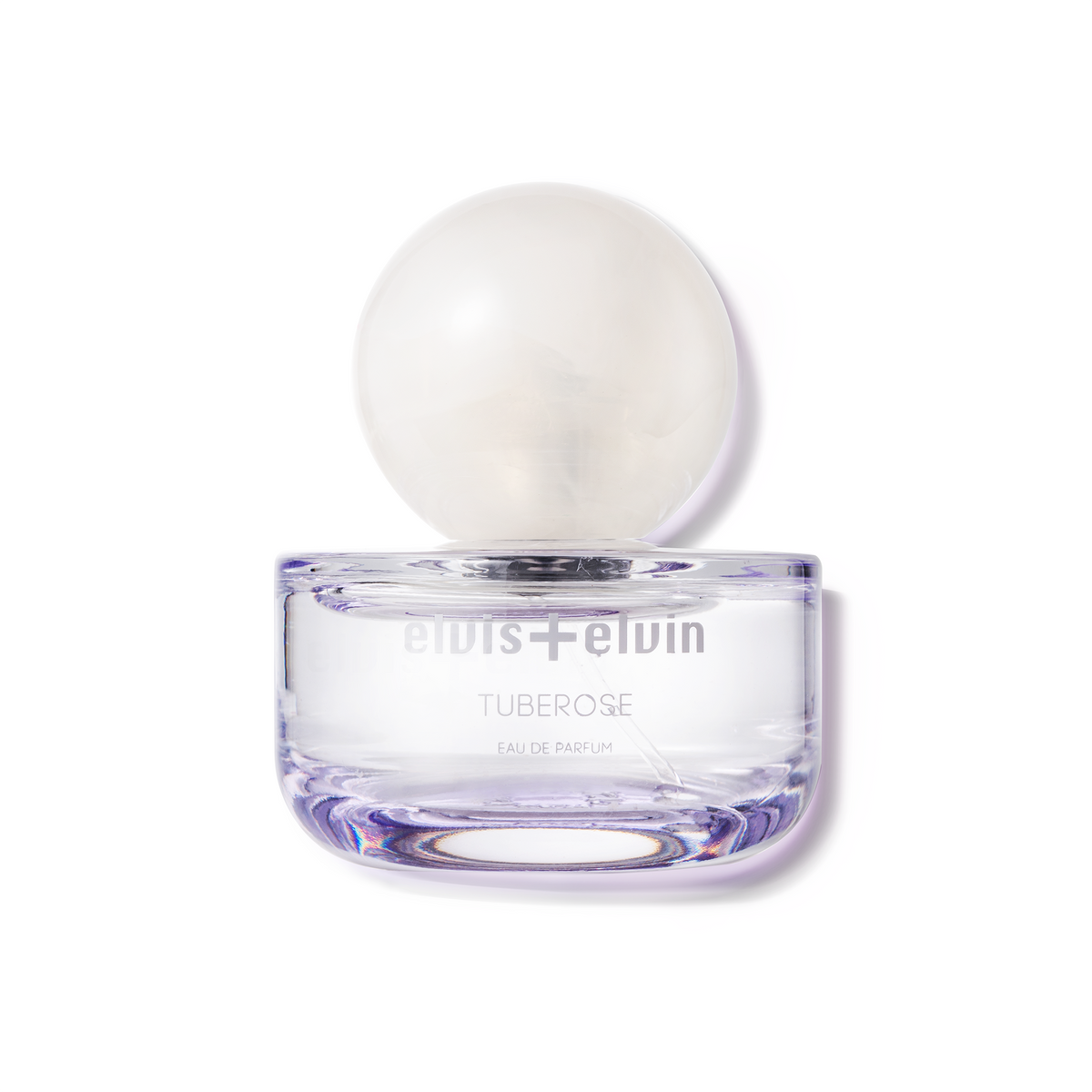 Tuberose eau de parfum bottle with round white cap in clear purple glass