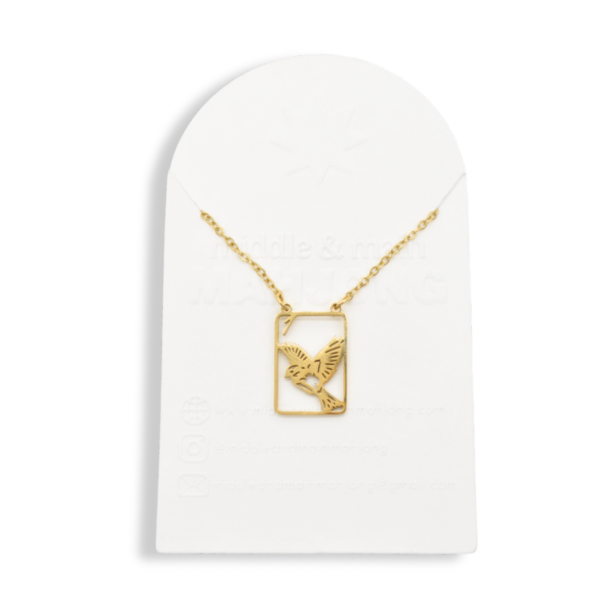 Gold necklace with square bird pendant on display stand