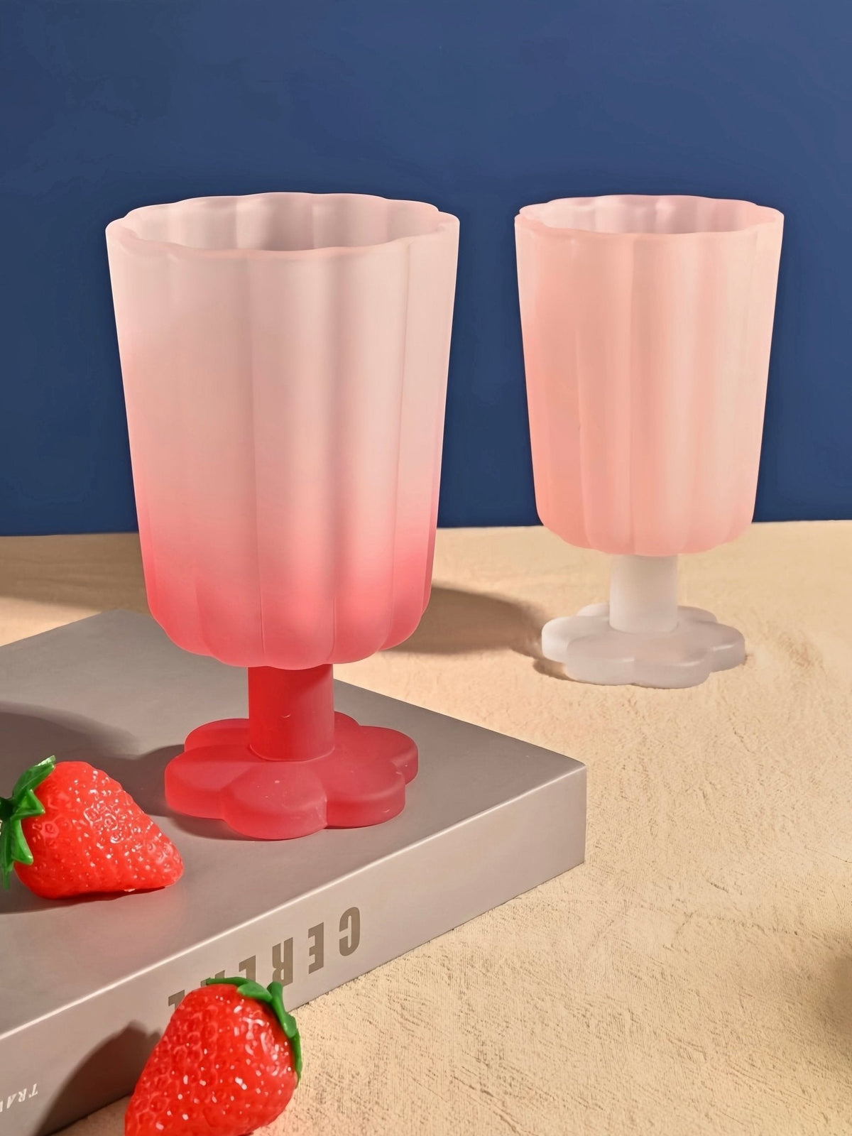Hand-blown petal goblet glasses, soft pink cups with matching white and red stems.