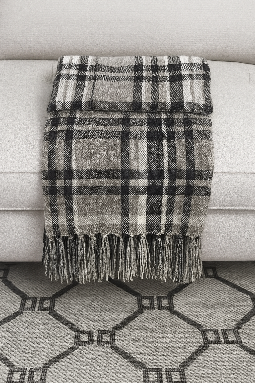 Plaid tassel throw blanket in black and gray with white stripes and fringe