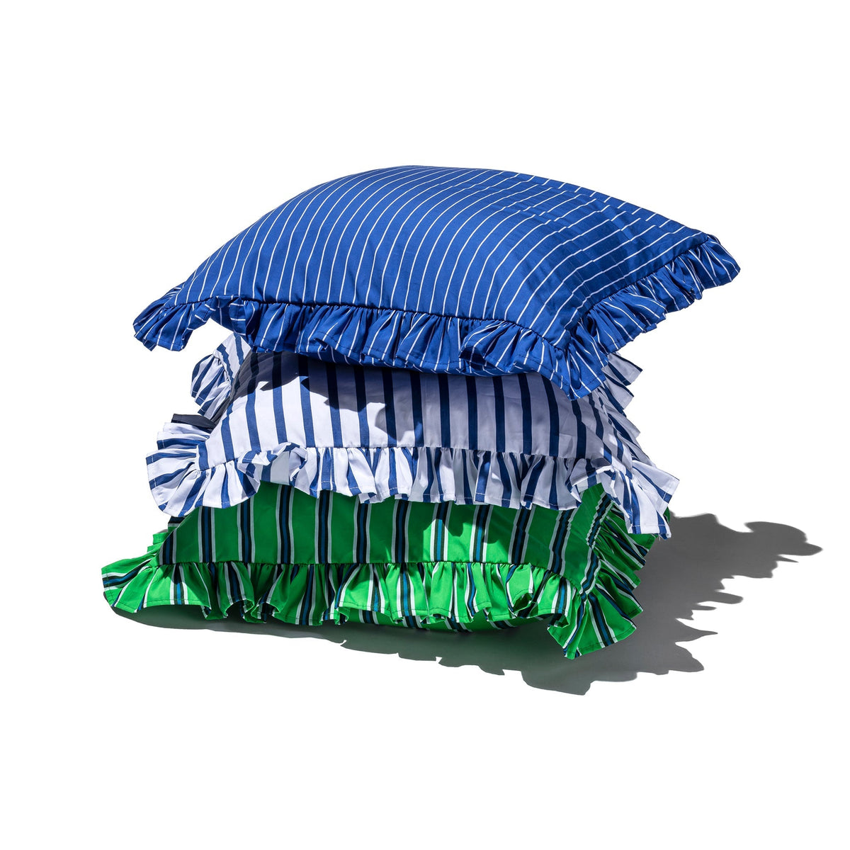 Stacked ruffle cushion covers with blue, dark, and green vertical stripes