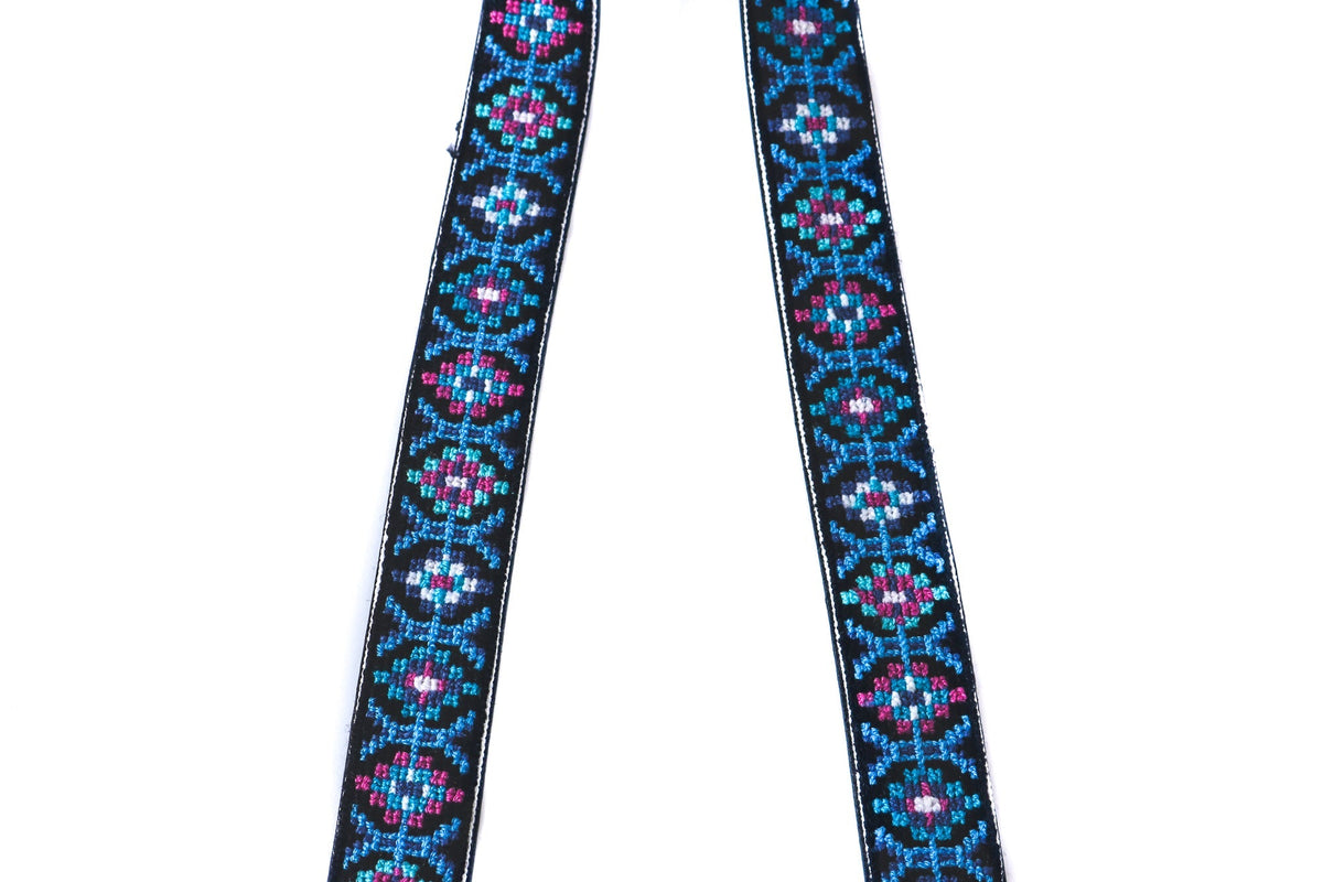 Mai woven bag strap close-up showing dark blue base with blue/pink geometric pattern