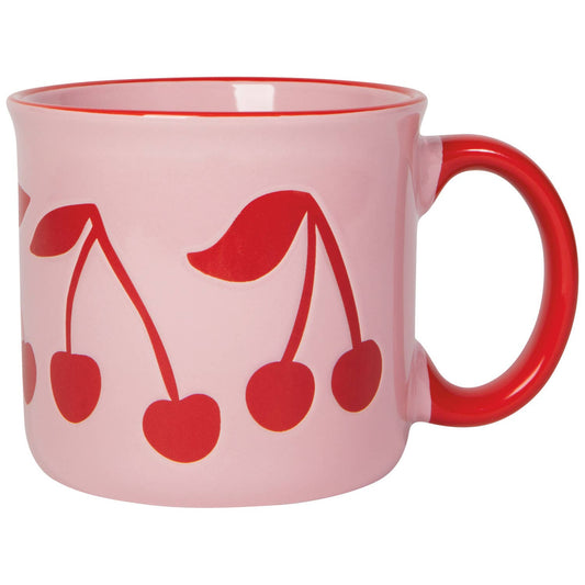 Pink ceramic mug with red cherry graphic design and red curved handle, close-up