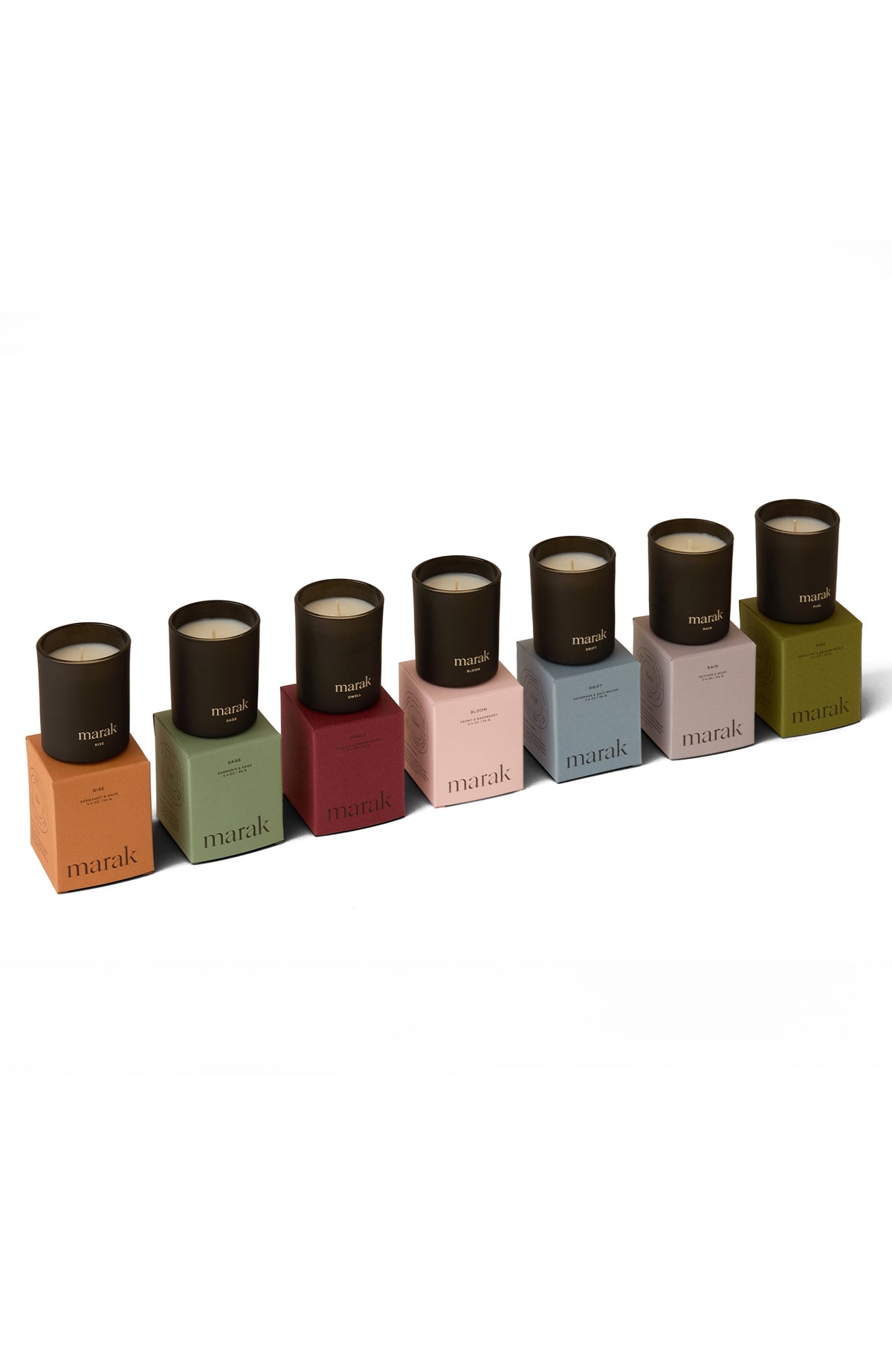 Mini votive candle set with black lids over color blocks, arranged in a line
