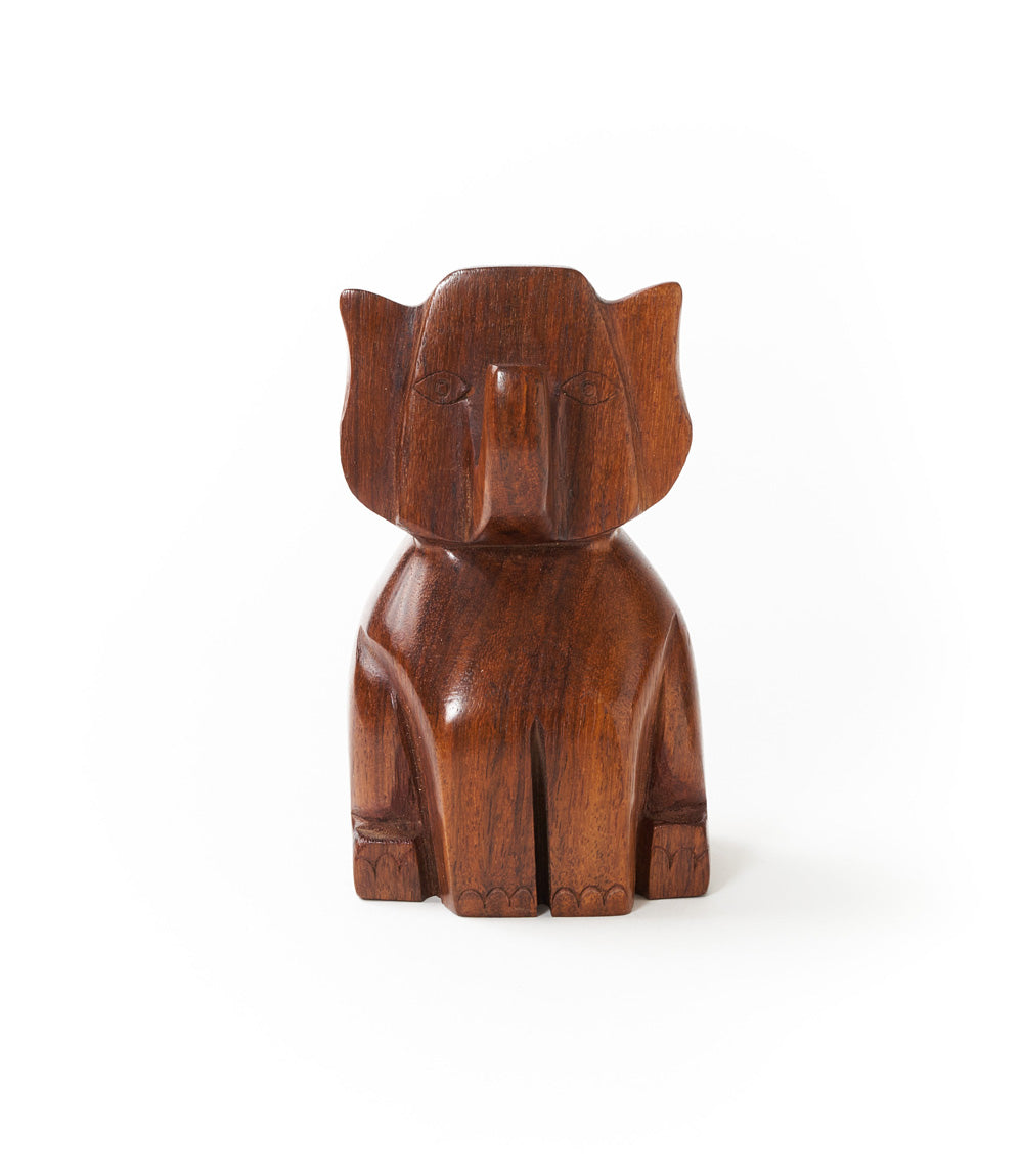 Hand-carved wooden elephant eyeglass holder stand, centered trunk-up profile.