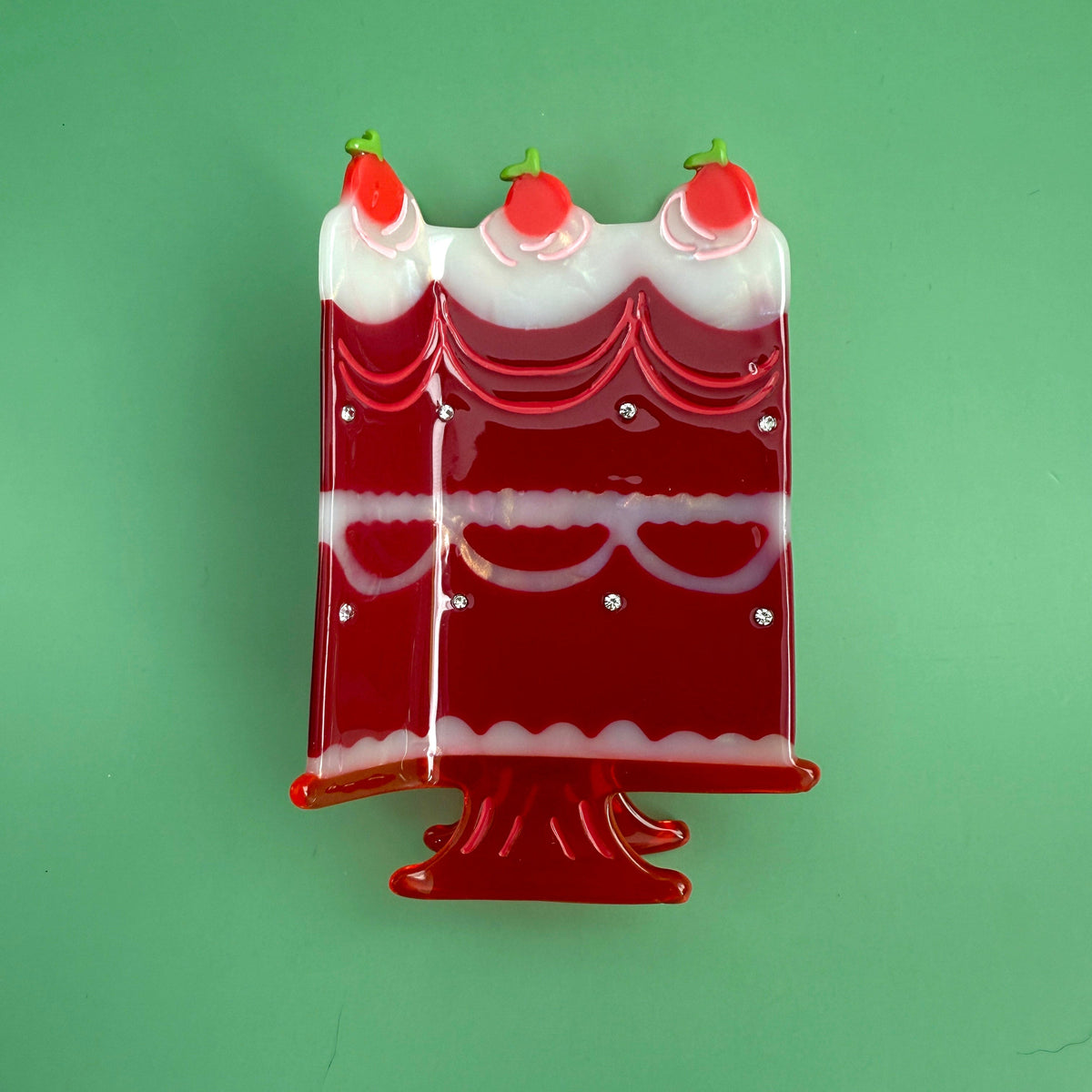 Red and white cake hair clip with three cherry candle caps and glossy detailing