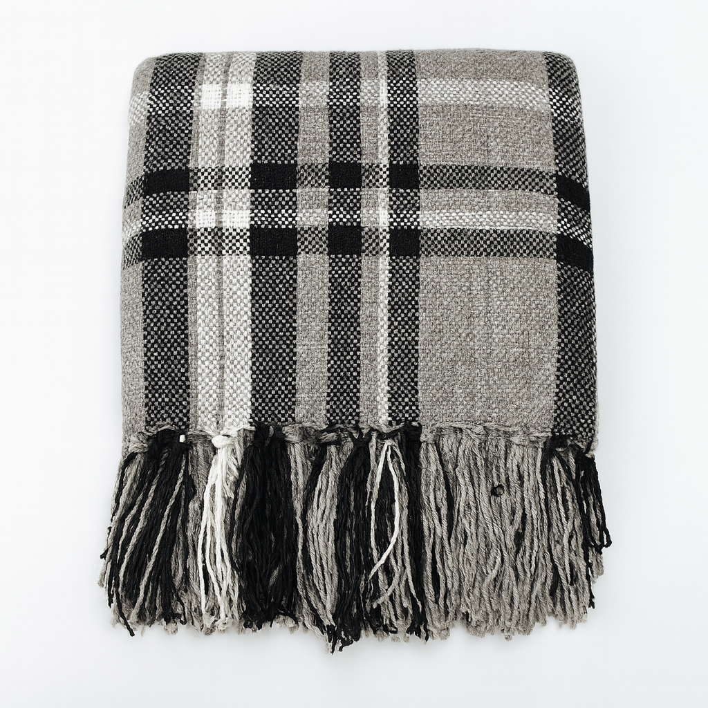 Plaid tassel throw blanket in black, white, and gray with long fringe border