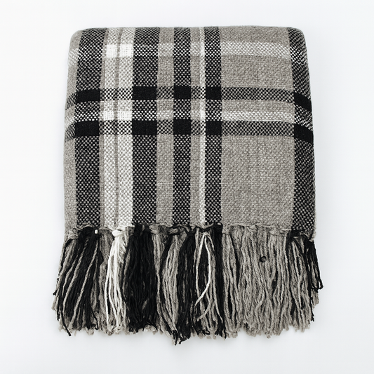 Plaid tassel throw blanket in black, white, and gray with long fringe border